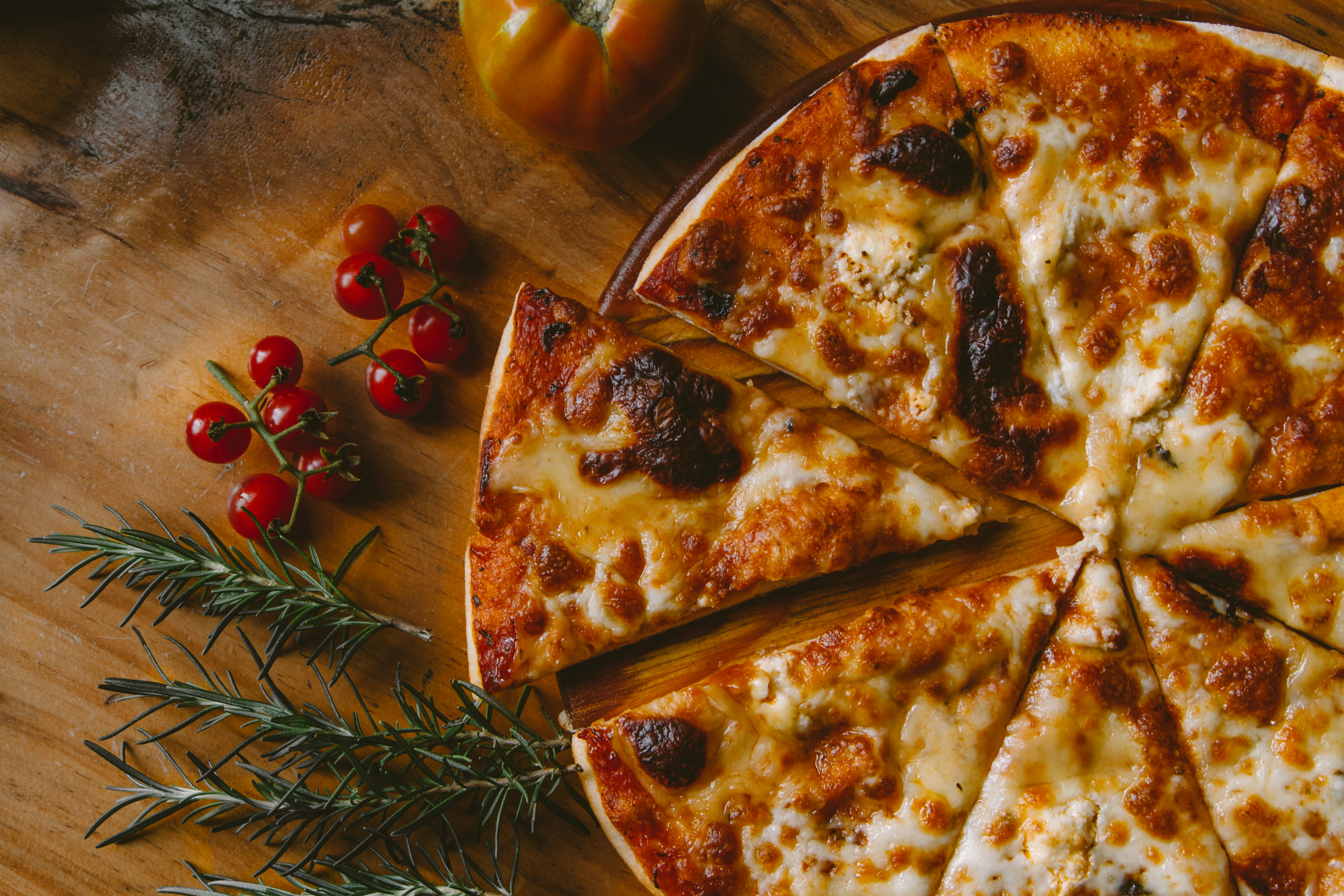 a crispy pizza on a wooden plate